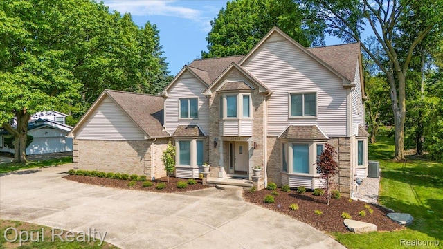 37456 Rhonswood Dr, Northville, MI 48167 - view of front of property with brick siding and roof with shingles