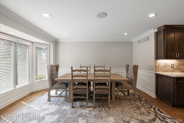 37456 Rhonswood Dr, Northville, MI 48167 - dining space featuring crown molding, light wood-type flooring, recessed lighting, and wainscoting