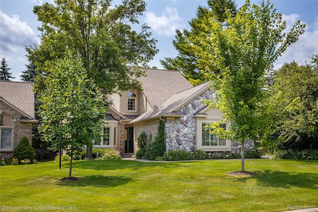 45330 Stonehedge Dr Unit 2, Plymouth, MI 48170 - view of front of home featuring stone siding, a front lawn, and a shingled roof