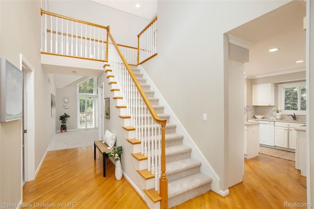 45330 Stonehedge Dr Unit 2, Plymouth, MI 48170 - stairway featuring wood finished floors, healthy amount of natural light, crown molding, and recessed lighting
