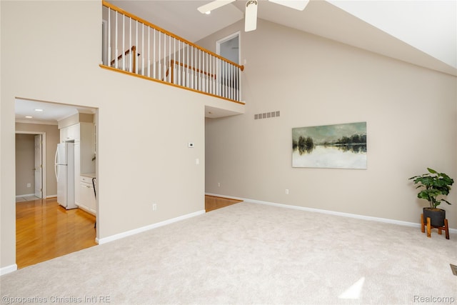 45330 Stonehedge Dr Unit 2, Plymouth, MI 48170 - unfurnished living room featuring light colored carpet, high vaulted ceiling, and a ceiling fan