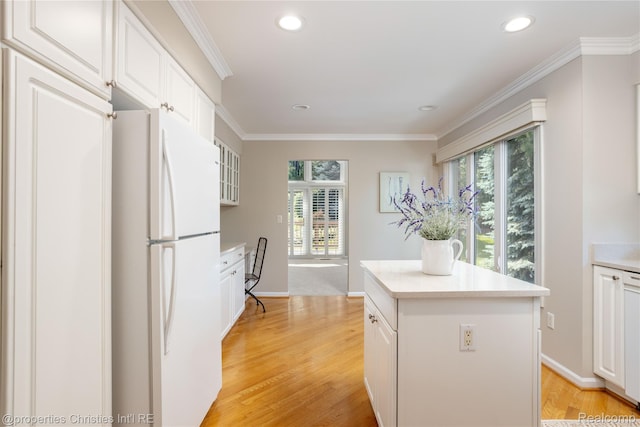 45330 Stonehedge Dr Unit 2, Plymouth, MI 48170 - kitchen with freestanding refrigerator, a kitchen island, white cabinetry, recessed lighting, and crown molding