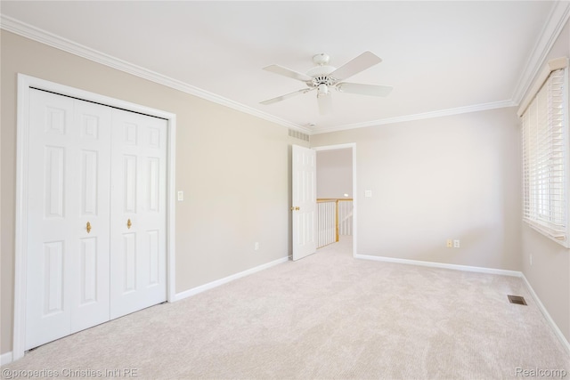 45330 Stonehedge Dr Unit 2, Plymouth, MI 48170 - unfurnished bedroom featuring ornamental molding, carpet flooring, a closet, and ceiling fan