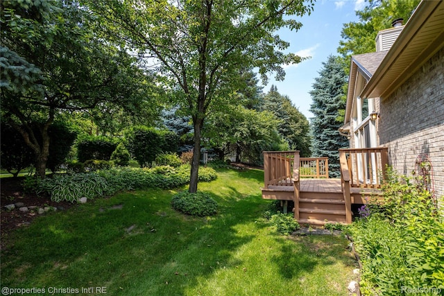 45330 Stonehedge Dr Unit 2, Plymouth, MI 48170 - view of grassy yard with a wooden deck and view of wooded area
