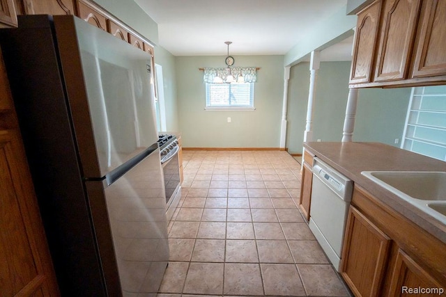 15065 Westlake St, Taylor, MI 48180 - kitchen with stainless steel appliances, a chandelier, brown cabinets, decorative light fixtures, and light tile patterned floors