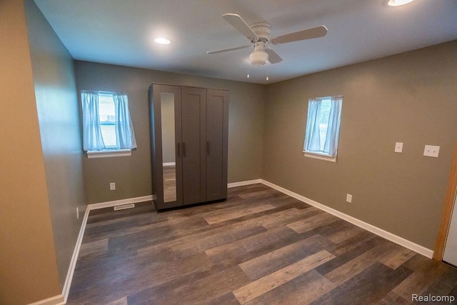 15065 Westlake St, Taylor, MI 48180 - unfurnished bedroom with multiple windows, dark wood-style floors, recessed lighting, and ceiling fan