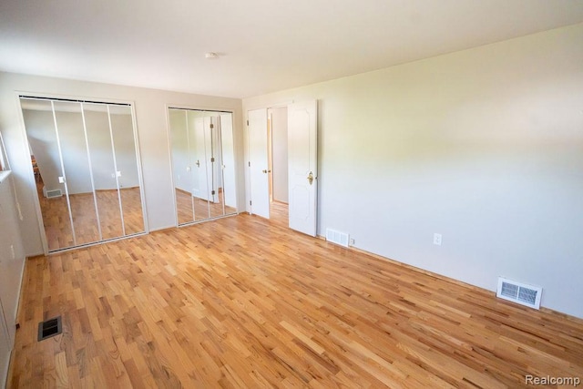 15065 Westlake St, Taylor, MI 48180 - unfurnished bedroom with light wood finished floors and two closets