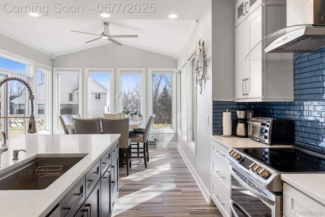 1079 Forest Bay Dr, Waterford, MI 48328 - kitchen featuring a sink, electric stove, wall chimney range hood, light countertops, and a ceiling fan