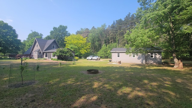 11390 Patterson Rd, Ravenna, MI 49451 - view of grassy yard with a fire pit