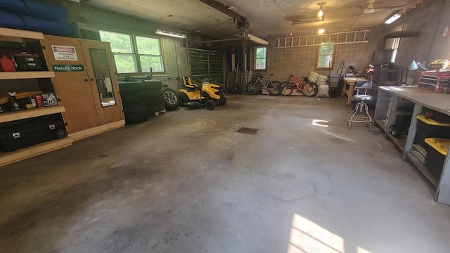 11390 Patterson Rd, Ravenna, MI 49451 - garage with a workshop area and concrete block wall