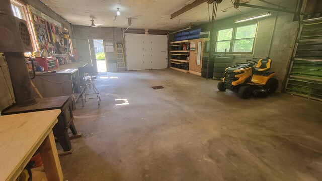11390 Patterson Rd, Ravenna, MI 49451 - garage featuring a workshop area and concrete block wall