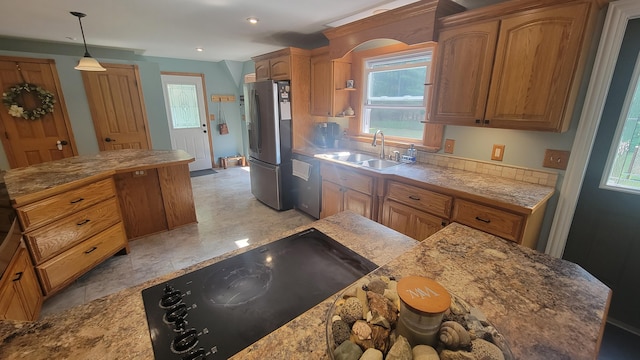 11390 Patterson Rd, Ravenna, MI 49451 - kitchen with stainless steel appliances, a sink, a kitchen island, brown cabinetry, and recessed lighting