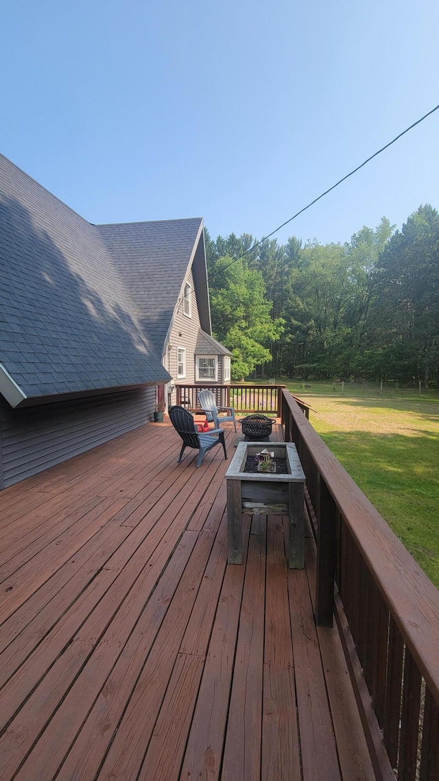 11390 Patterson Rd, Ravenna, MI 49451 - wooden deck with an outdoor fire pit and a lawn