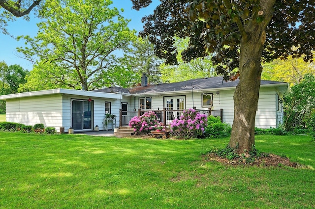 2877 Bessemer Rd, Coloma, MI 49038 - rear view of house featuring a lawn and a wooden deck