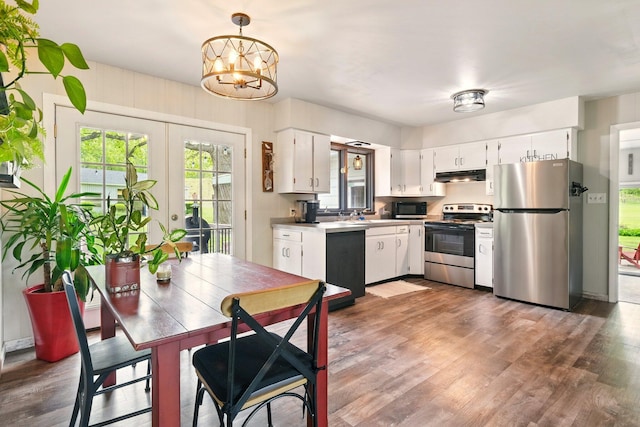 2877 Bessemer Rd, Coloma, MI 49038 - kitchen featuring stainless steel appliances, under cabinet range hood, white cabinetry, and wood finished floors