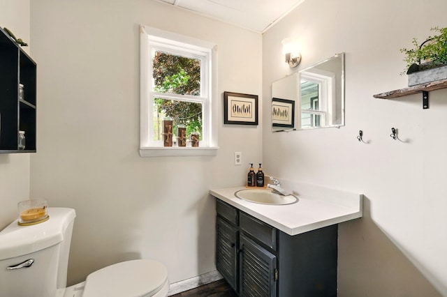 2877 Bessemer Rd, Coloma, MI 49038 - bathroom with toilet, vanity, and baseboards