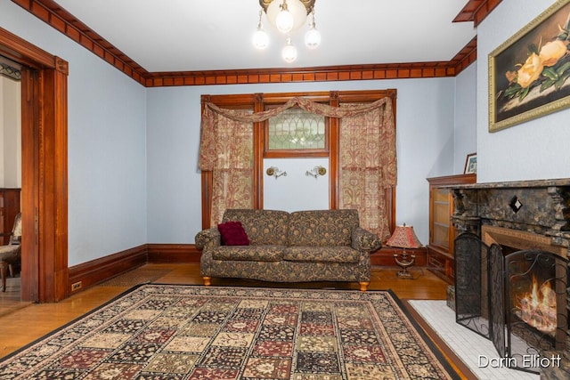 216 E Main St, Ionia, MI 48846 - living area featuring wood finished floors, a fireplace with flush hearth, and baseboards