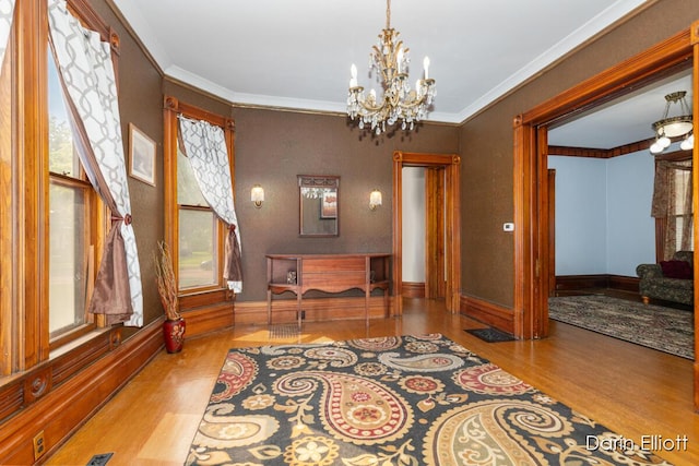 216 E Main St, Ionia, MI 48846 - office with wood finished floors, a chandelier, plenty of natural light, baseboards, and crown molding