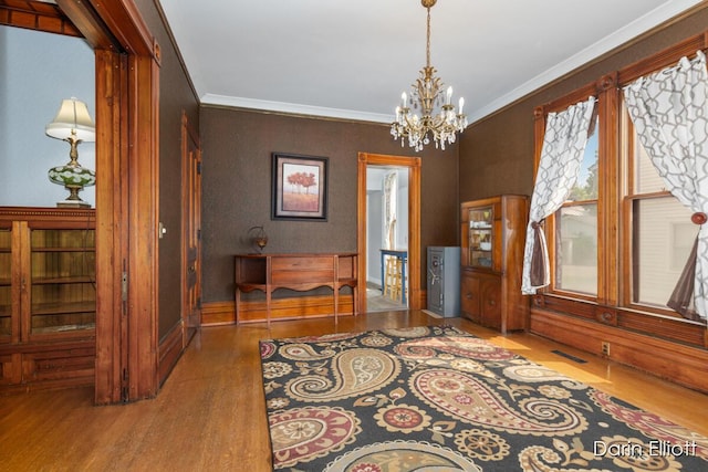 216 E Main St, Ionia, MI 48846 - dining room with wood finished floors, a chandelier, and crown molding
