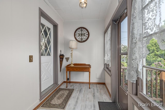 216 E Main St, Ionia, MI 48846 - entrance foyer with light wood finished floors, healthy amount of natural light, crown molding, and baseboards