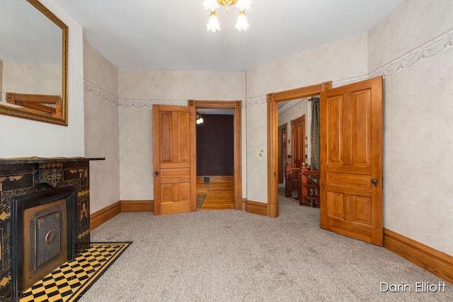 216 E Main St, Ionia, MI 48846 - living room with carpet, a chandelier, and baseboards