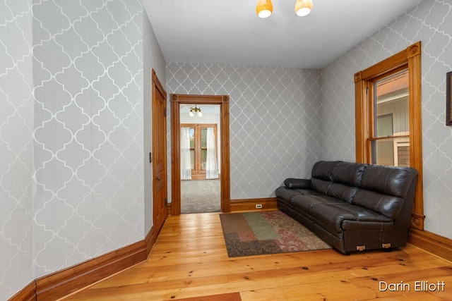 216 E Main St, Ionia, MI 48846 - living area with light wood-style flooring, baseboards, and french doors