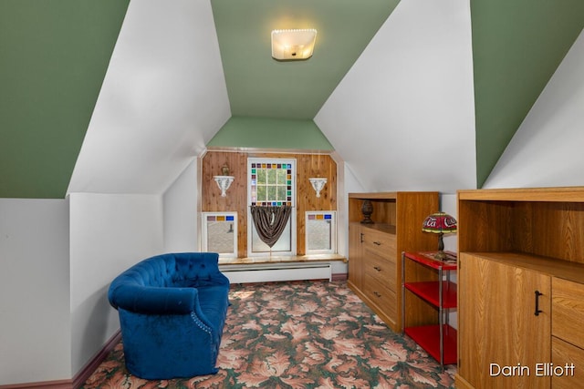 216 E Main St, Ionia, MI 48846 - living area featuring lofted ceiling, carpet, and a baseboard radiator