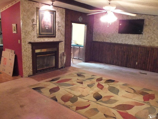 411 Norwood Dr, Monroe, MI 48161 - carpeted living room featuring a ceiling fan, wainscoting, a large fireplace, wood walls, and wallpapered walls