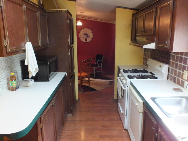 411 Norwood Dr, Monroe, MI 48161 - kitchen with white appliances, dark wood-type flooring, under cabinet range hood, backsplash, and light countertops
