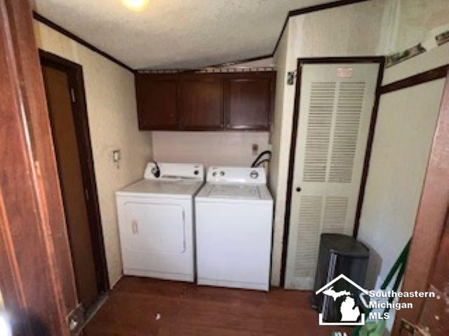 411 Norwood Dr, Monroe, MI 48161 - washroom featuring washer and dryer, cabinet space, and dark wood finished floors