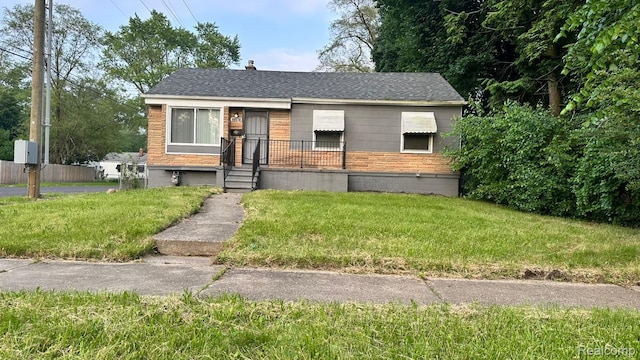 19978 Grandview St, Detroit, MI 48219 - bungalow-style home featuring a front yard, a chimney, roof with shingles, and brick siding