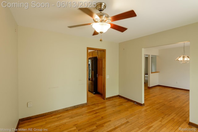 5590 Bayswater Rd, West Bloomfield, MI 48322 - unfurnished room with light wood-type flooring, a chandelier, and a ceiling fan