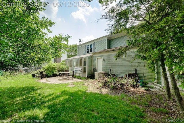 5590 Bayswater Rd, West Bloomfield, MI 48322 - back of property featuring a patio, a sunroom, and a yard