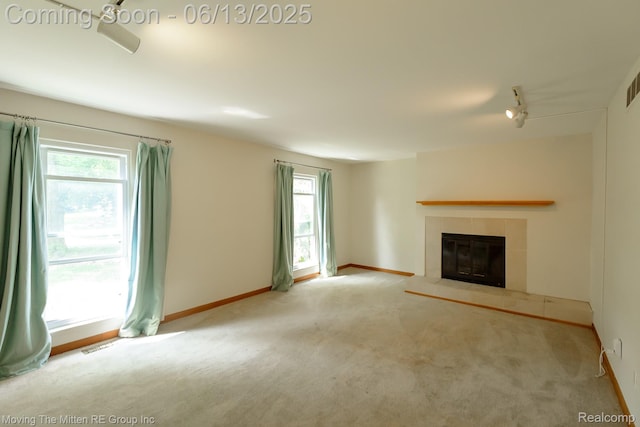 5590 Bayswater Rd, West Bloomfield, MI 48322 - unfurnished living room with plenty of natural light, carpet, and a tile fireplace
