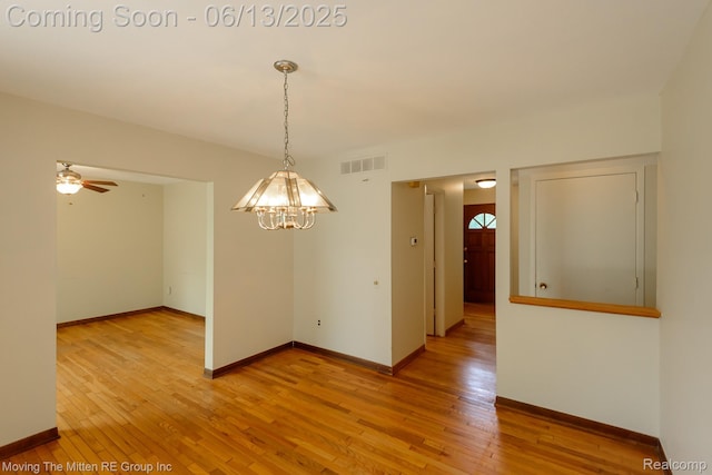 5590 Bayswater Rd, West Bloomfield, MI 48322 - unfurnished dining area with a chandelier, light wood-style flooring, and a ceiling fan