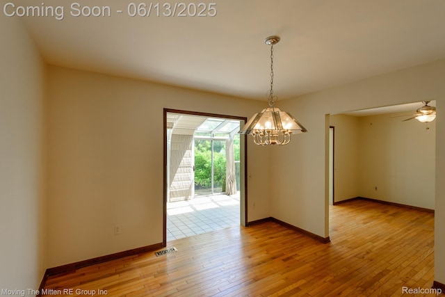 5590 Bayswater Rd, West Bloomfield, MI 48322 - unfurnished room featuring a chandelier and light wood finished floors