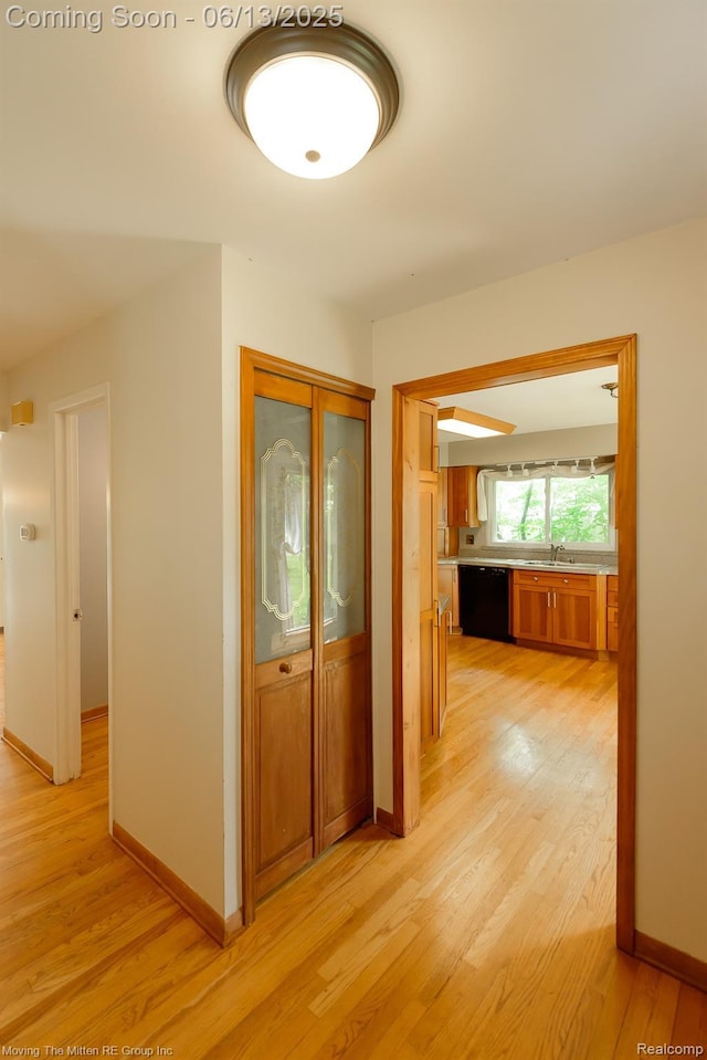 5590 Bayswater Rd, West Bloomfield, MI 48322 - corridor featuring light wood-type flooring and a sink