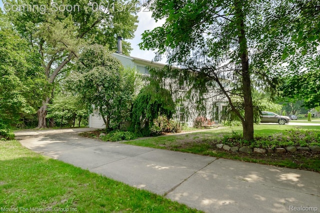5590 Bayswater Rd, West Bloomfield, MI 48322 - view of home's community with a garage and a yard
