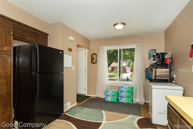 32712 Columbus Dr, Warren, MI 48088 - kitchen with freestanding refrigerator, refrigerator, light countertops, dark brown cabinets, and baseboards