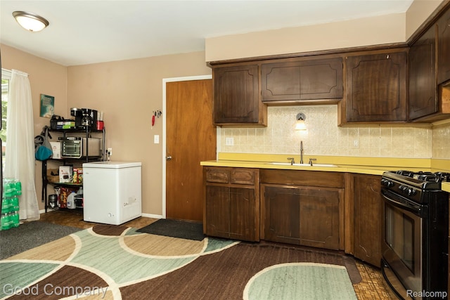 32712 Columbus Dr, Warren, MI 48088 - kitchen with a sink, gas range, white fridge, light countertops, and backsplash