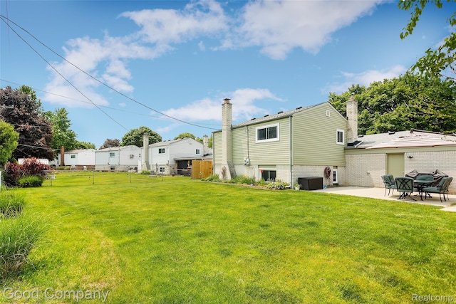 32712 Columbus Dr, Warren, MI 48088 - rear view of house with a chimney, a patio, and cooling unit