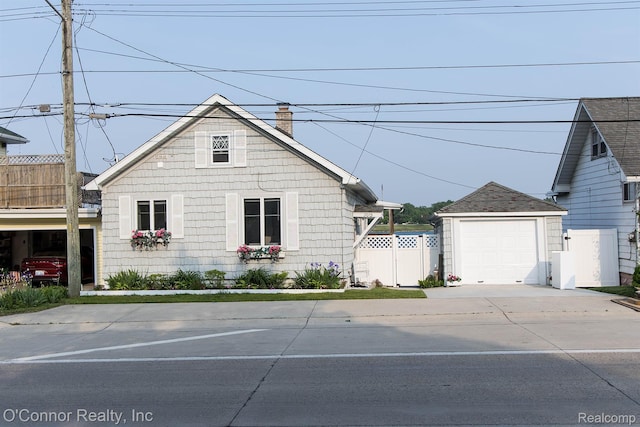 105 Gratiot Blvd, Marysville, MI 48040 - view of front facade featuring a chimney, concrete driveway, and a garage