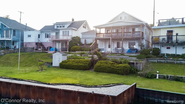 105 Gratiot Blvd, Marysville, MI 48040 - back of house with a balcony, a residential view, and a lawn
