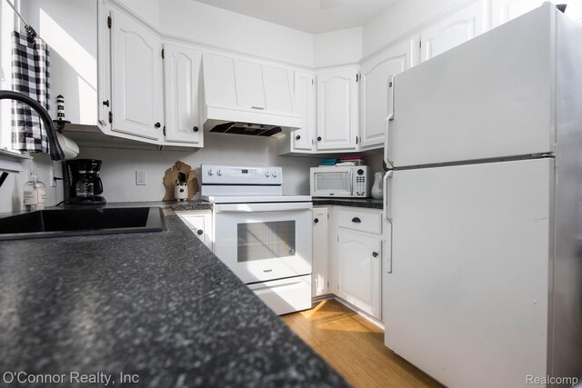 105 Gratiot Blvd, Marysville, MI 48040 - kitchen with white appliances, a sink, dark countertops, and white cabinetry
