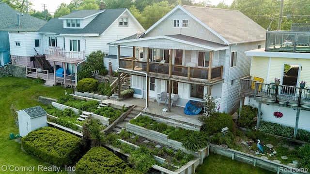 105 Gratiot Blvd, Marysville, MI 48040 - back of house featuring stairway, a garden, a patio area, and a wooden deck