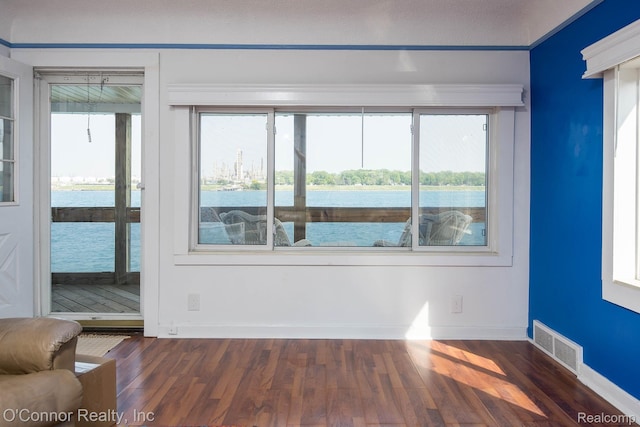 105 Gratiot Blvd, Marysville, MI 48040 - empty room with dark wood-style flooring, a water view, and baseboards