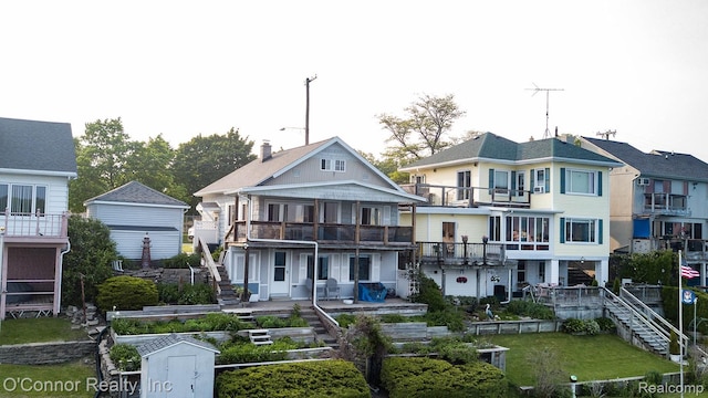 105 Gratiot Blvd, Marysville, MI 48040 - view of front facade with stairway, a balcony, a patio, and a storage unit