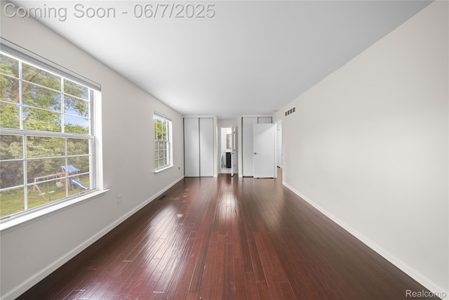 1633 Fleetwood Dr, Troy, MI 48098 - unfurnished living room with baseboards and dark wood-style floors