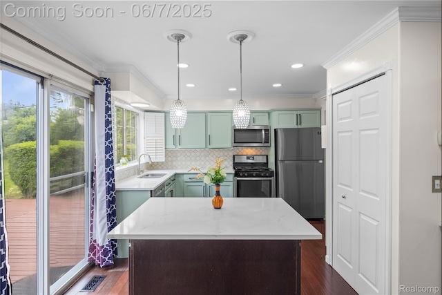 1633 Fleetwood Dr, Troy, MI 48098 - kitchen with appliances with stainless steel finishes, green cabinetry, ornamental molding, decorative backsplash, and a sink