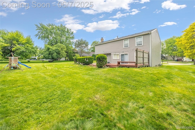 1633 Fleetwood Dr, Troy, MI 48098 - back of house with a yard, a wooden deck, a playground, and a chimney